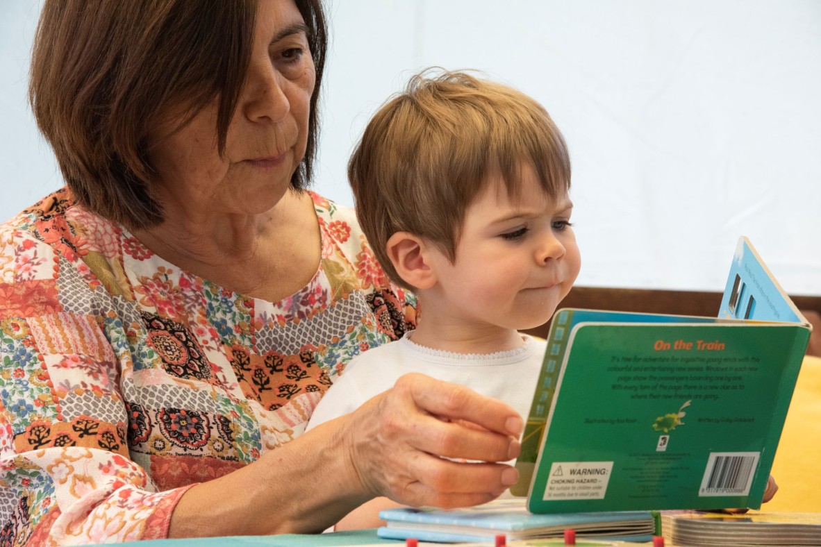 Grandmother and toddler reading book