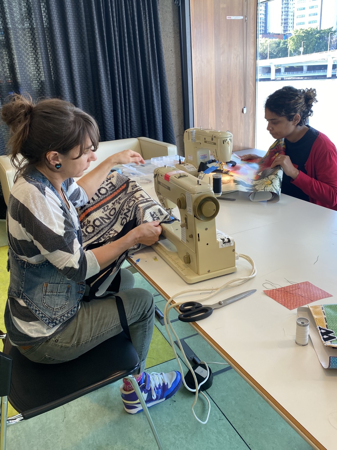 A photo of people sewing vinyl