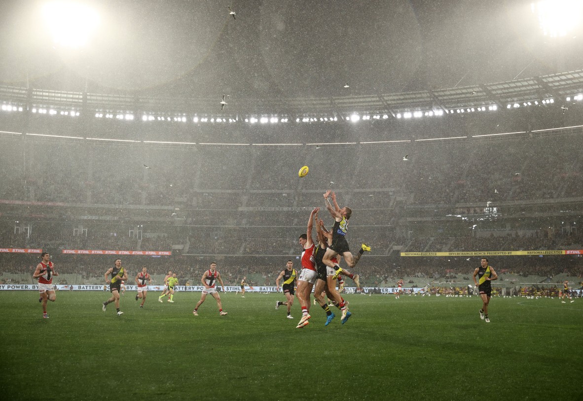 A photo of an AFL match in the rain