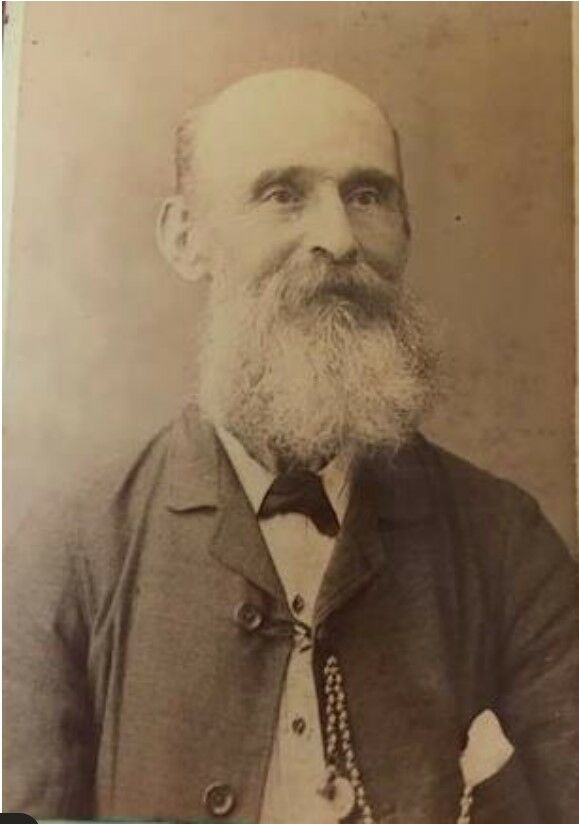 Sepia image of Robert Laws, a balding man with a beard, wearing a suit and pocket watch.