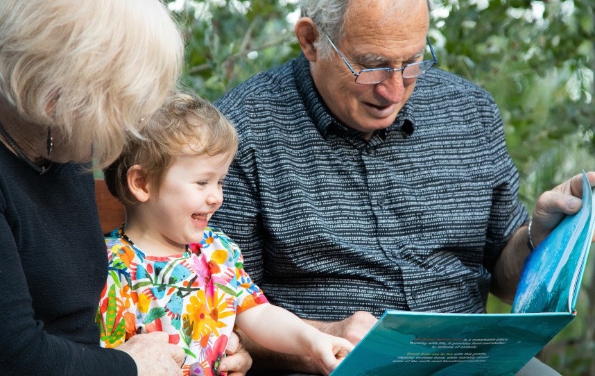 Grandparents reading with child