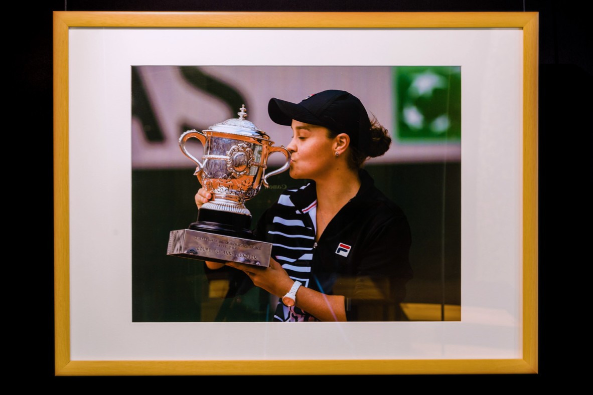 Framed photograph of Ash Barty kissing the winners cup