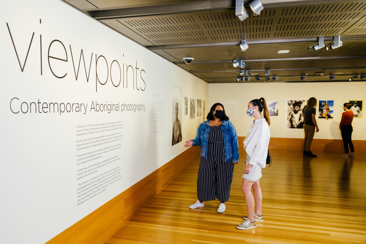 Two women look at the introduction text within the Viewpoints exhibition 