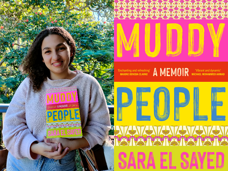 Sara El Sayed wears a jumper and jeans; she stands outside in front of a tree and holds her book 'Muddy People'