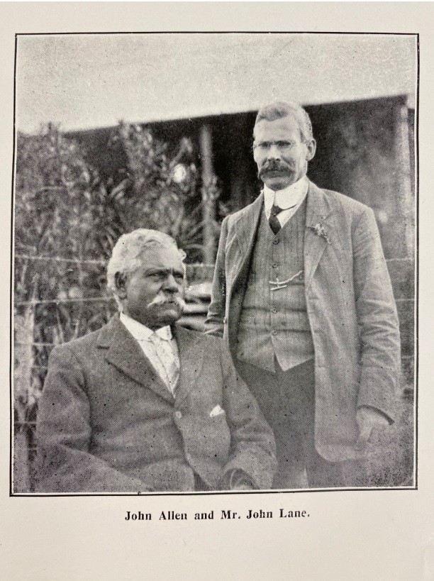 Photograph of two men, John Allen seated and John Lane standing beside him.