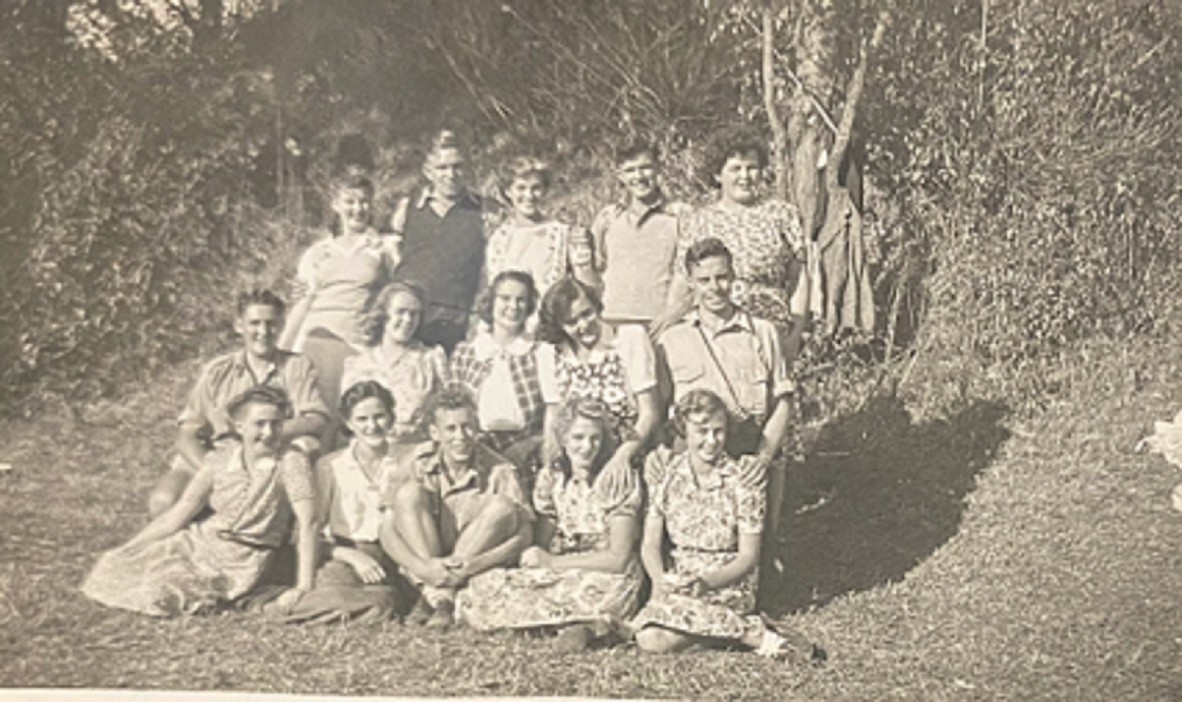 Black and White photograph of Fae Deviney Collins, nee King with family and friends in a garden. 