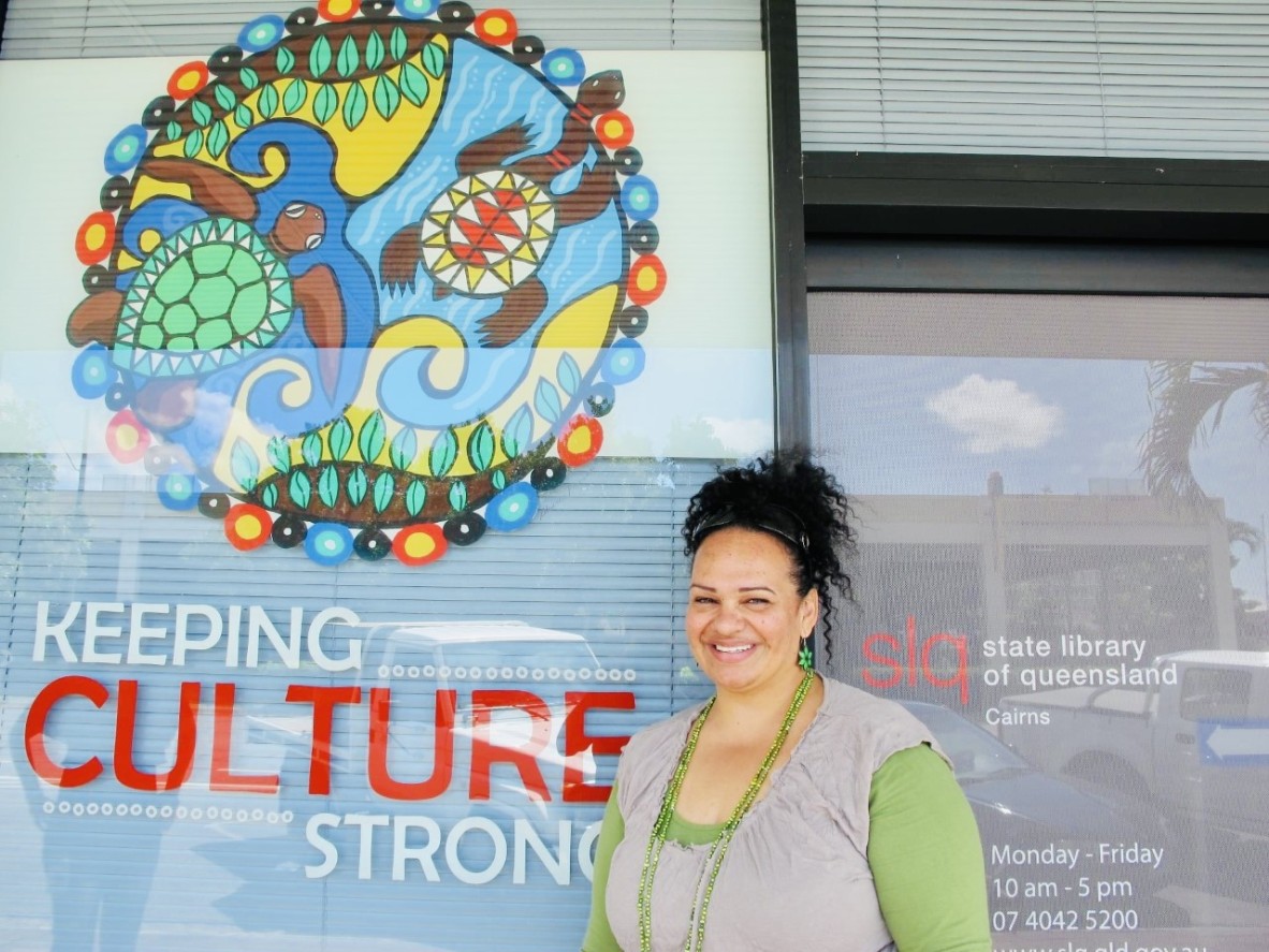 Woman standing beside keeping culture strong sign