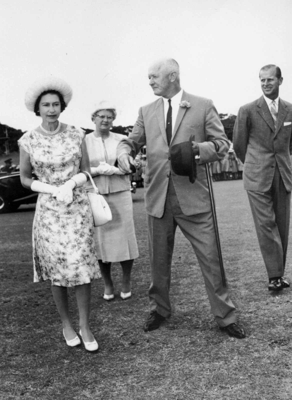 Queen Elizabeth II stands with a man, Sir Thomas Alfred Hiley at the Brisbane Cricket Ground