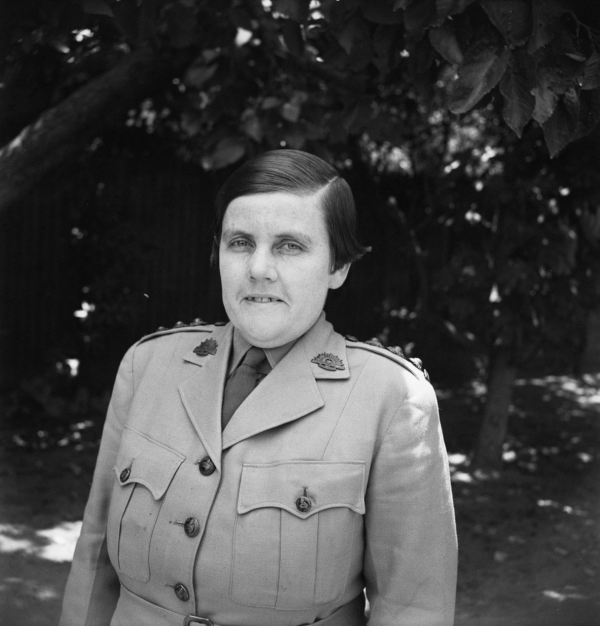 Head and shoulders of woman in defence uniform, 1944