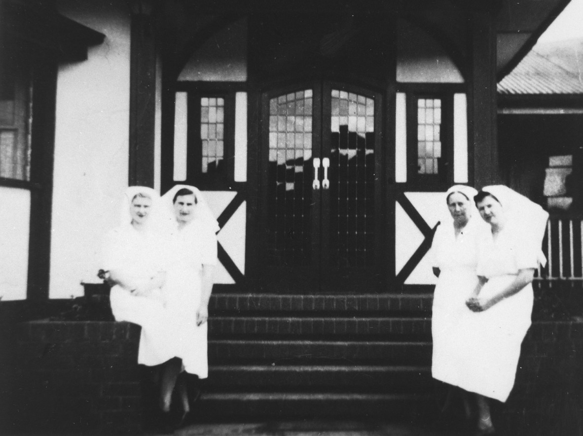 Nurses standing by the front steps outside St Aubyns Hospital in Kingaroy