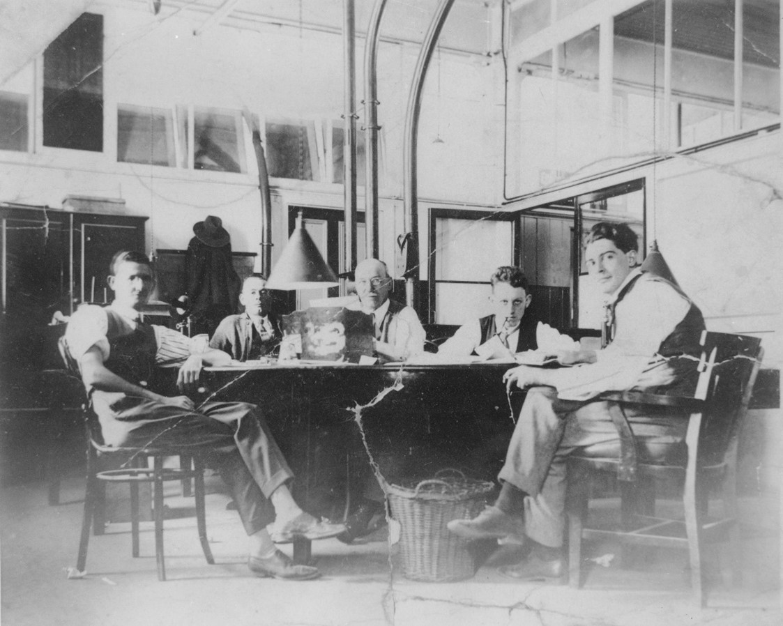 A group of men sitting around a table
