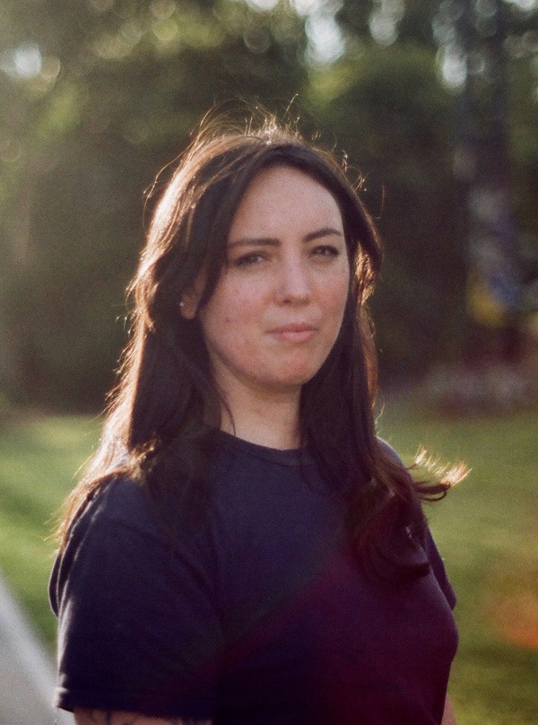 Susie Anderson with long dark hair wearing black tshirt