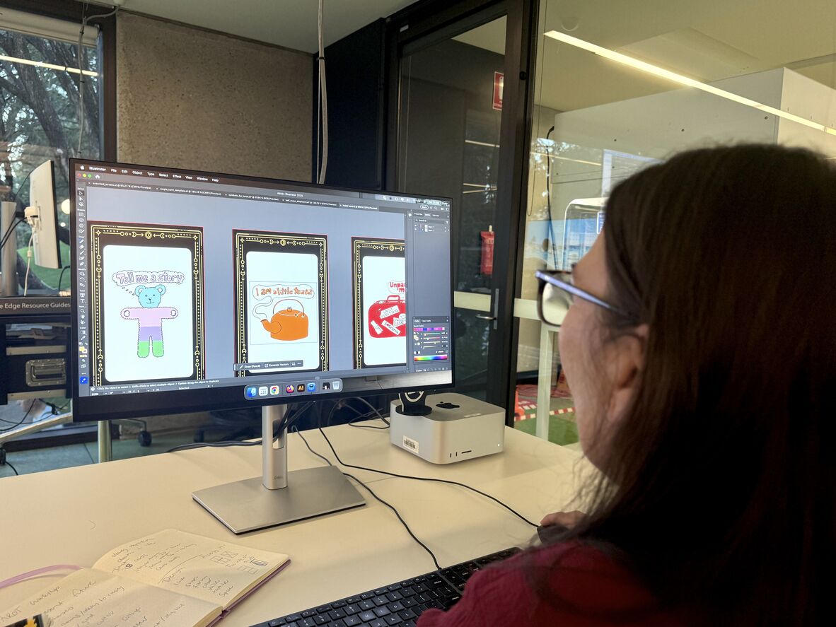 A photo of a woman working on a computer designing three Tarot card layouts