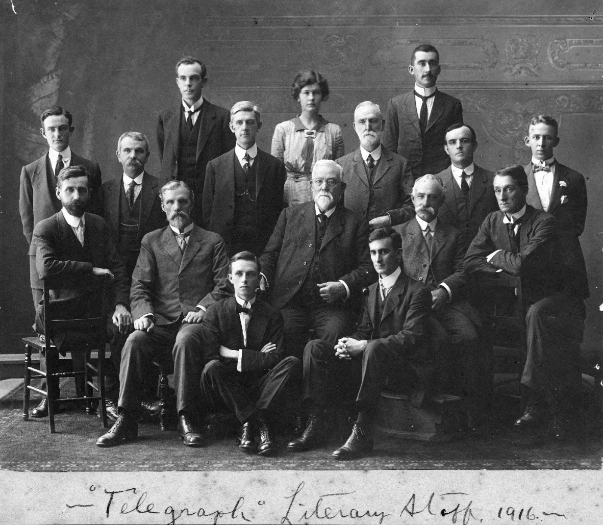 A group of men and one woman in professional attire