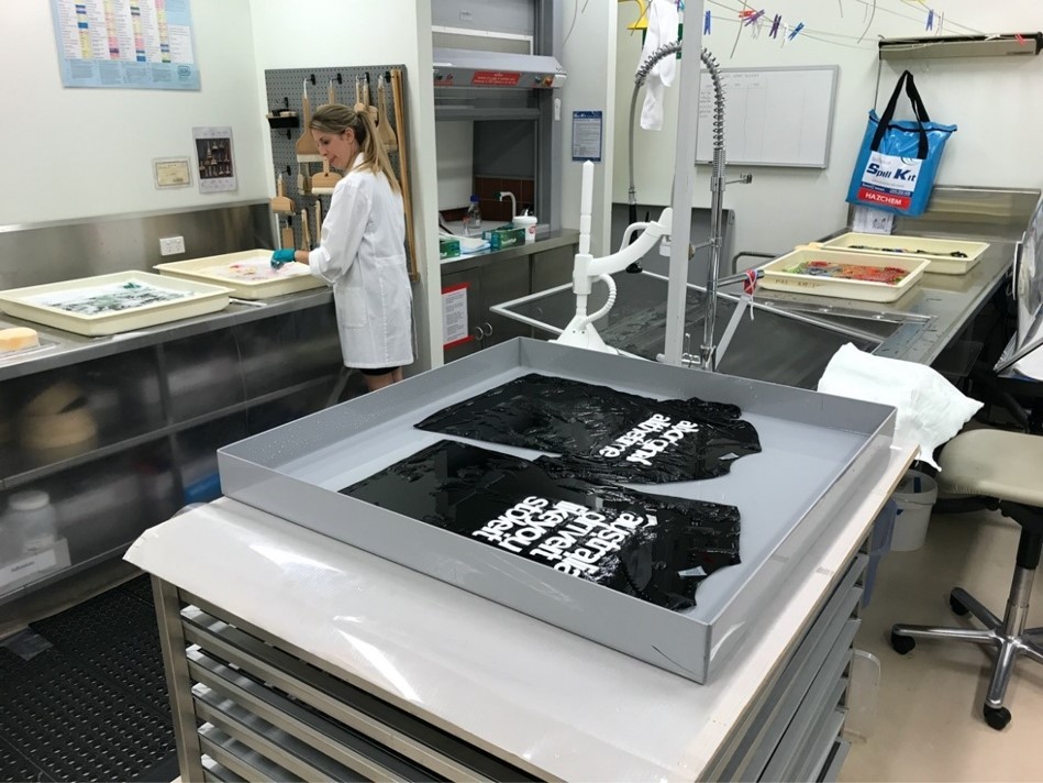 Textiles Conservator Louise McCullagh washing collection itemsinthe Preservation Services lab at State Library of Queensland