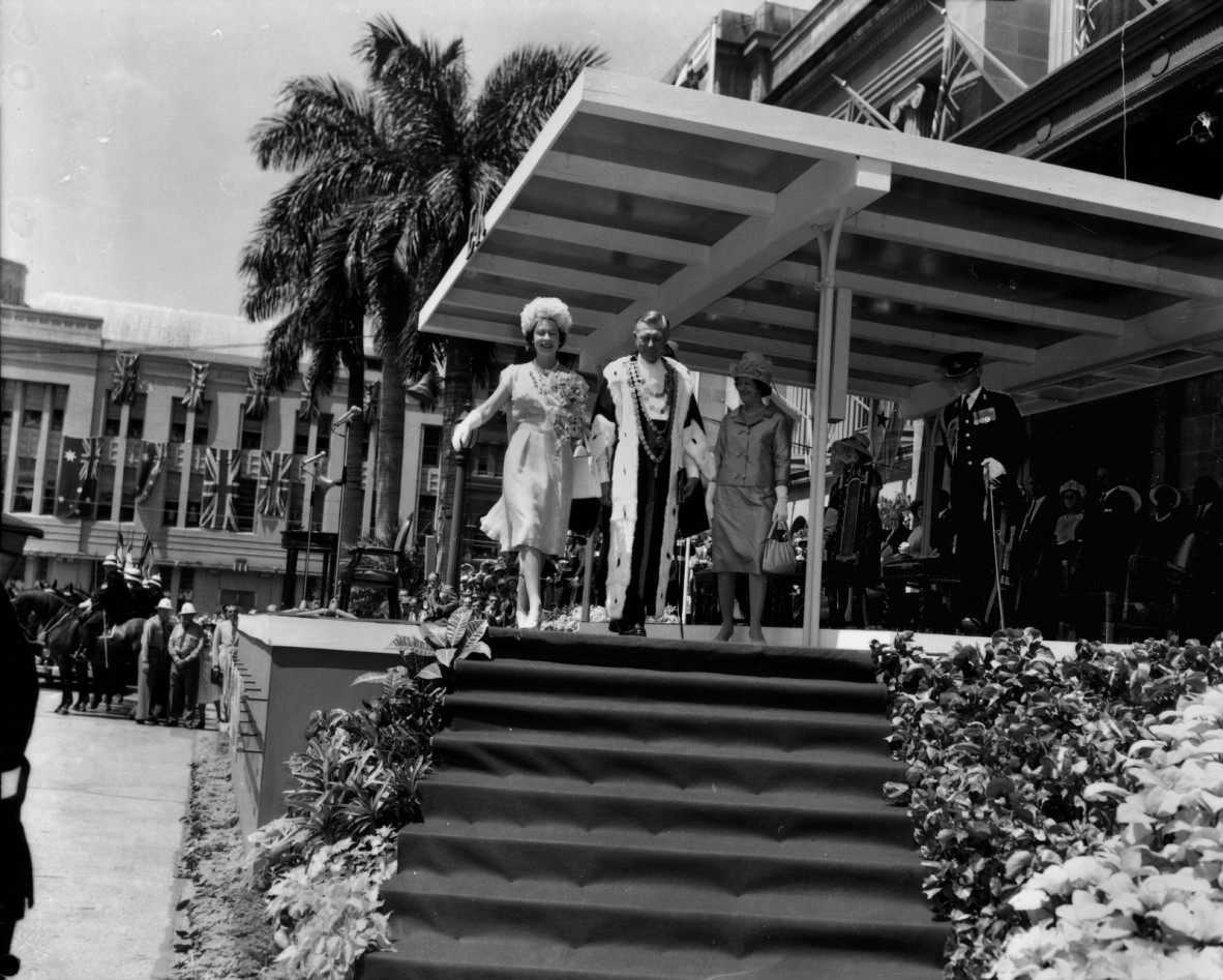 the queen walks down some steps