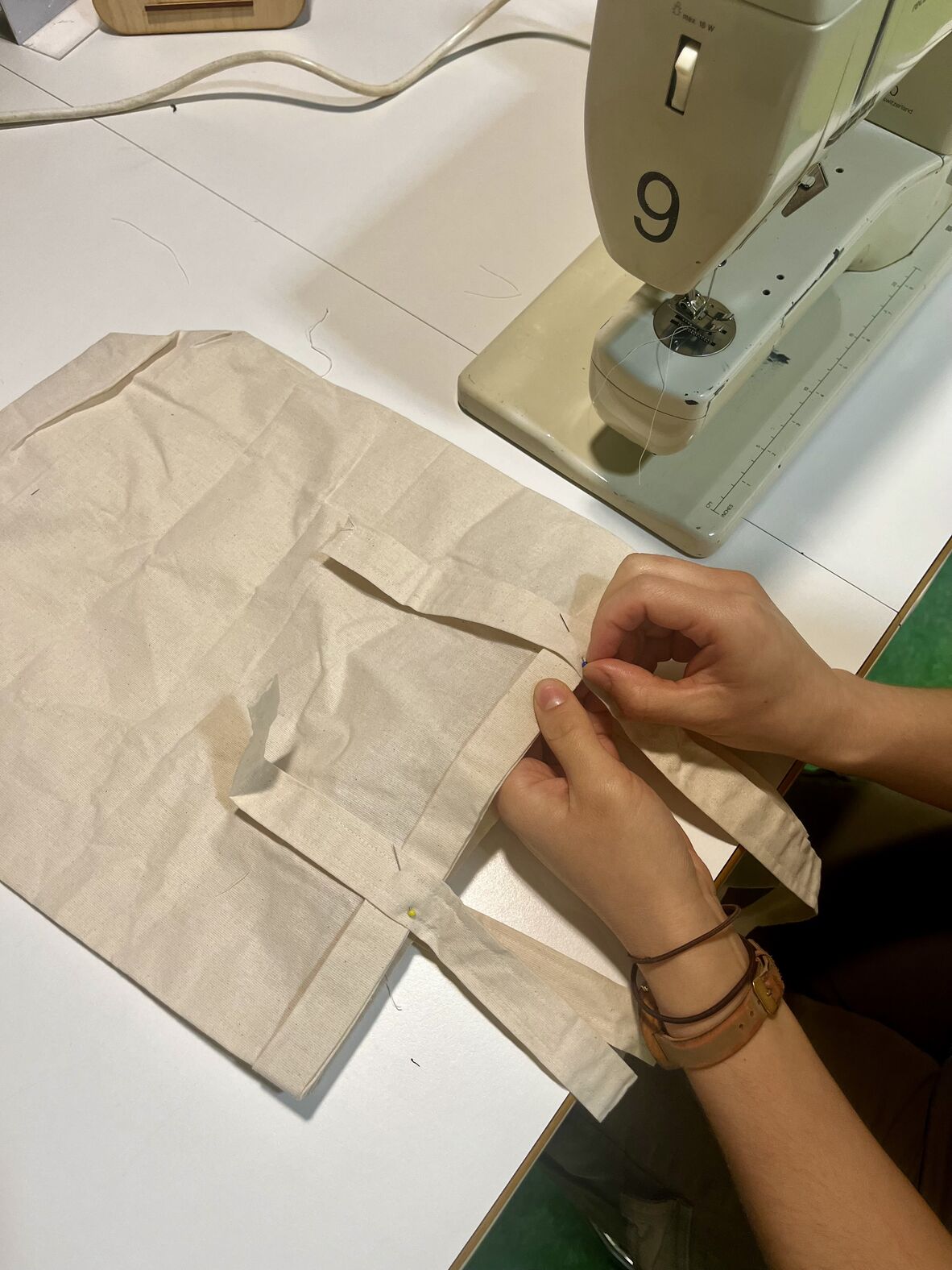 A photo of someone at a sewing machine stitching a bag