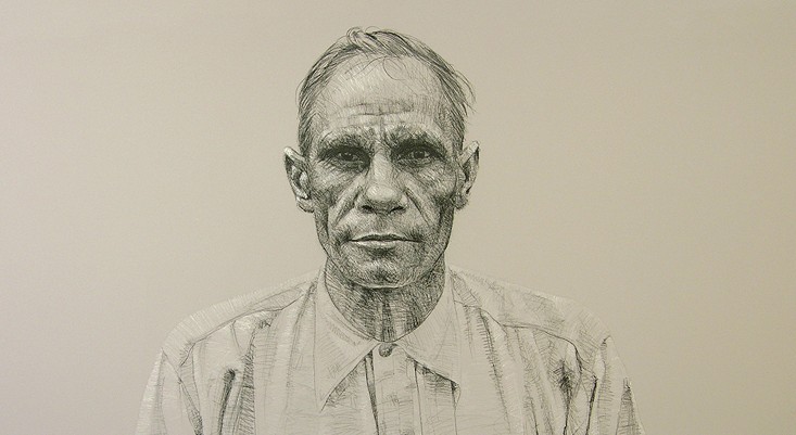 A charcoal portrait of a First Nations man wearing a button up shirt looking at the viewer