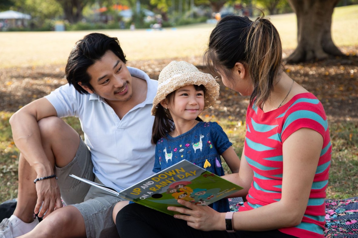 Family reading Up and Down on a Rainy Day book