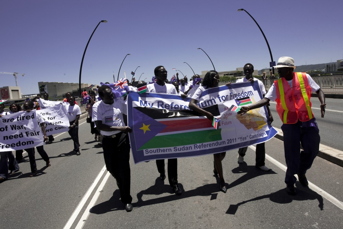  Demonstrators holding banners relating to the South Sudanese independence referendum proceeding along Victoria Bridge, Brisbane, December 2010