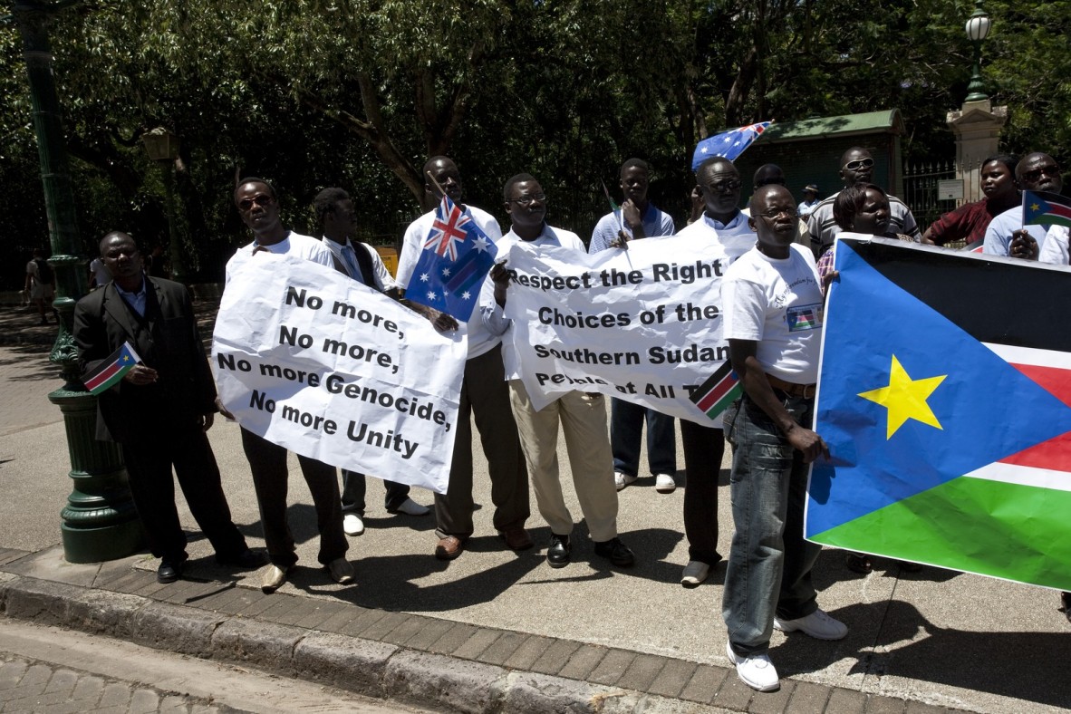 Demonstrators carrying signs relating to the South Sudanese independence referendum in Brisbane December 2010