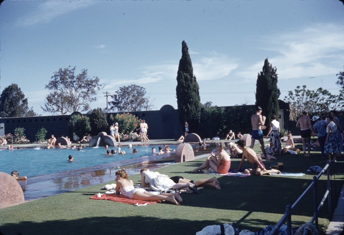 People relaxing by the swimming pool at the Oasis Gardens in Sunnybank