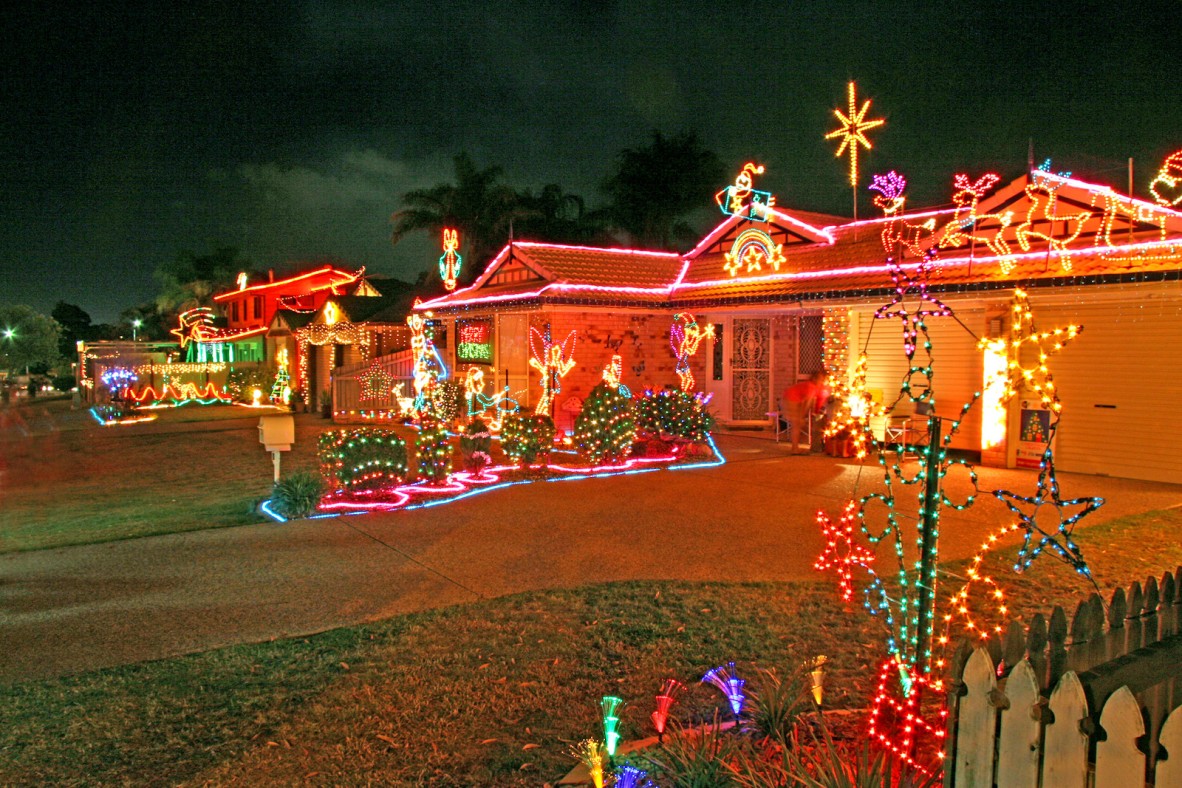 A series of houses decorated with Christmas lights on a street in South-east Queensland 