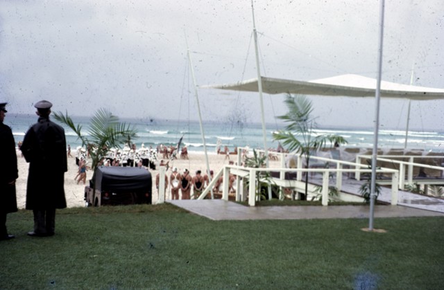view of a white undercover area overlooking a beach with surf life saving competitors