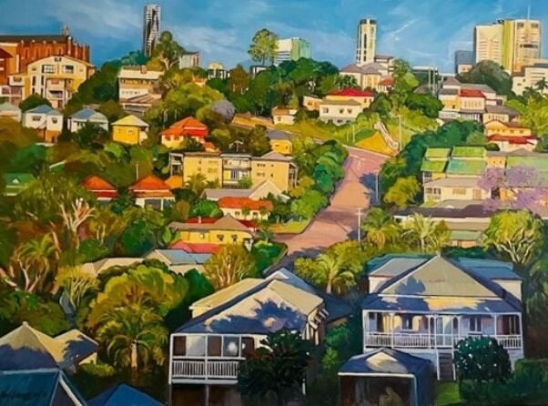 A scene of Queenslander houses on a hill surrounded by green space