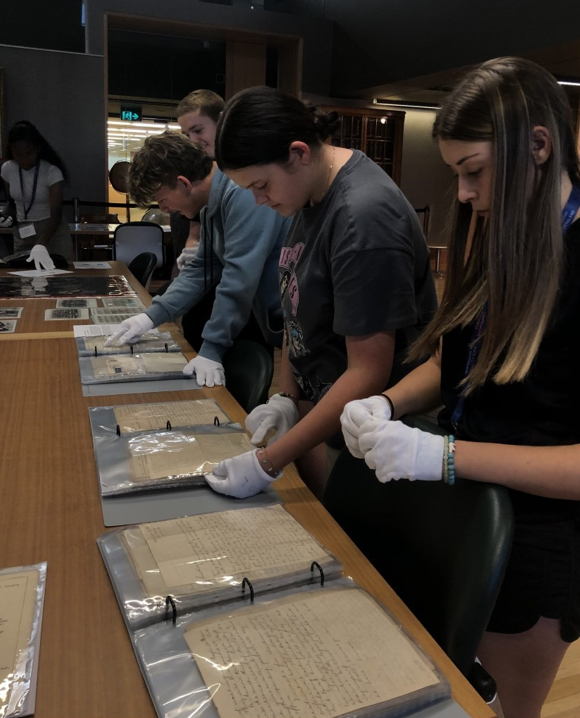 Participants engaging with State Library's collection of military diaries through a White Gloves Experience.