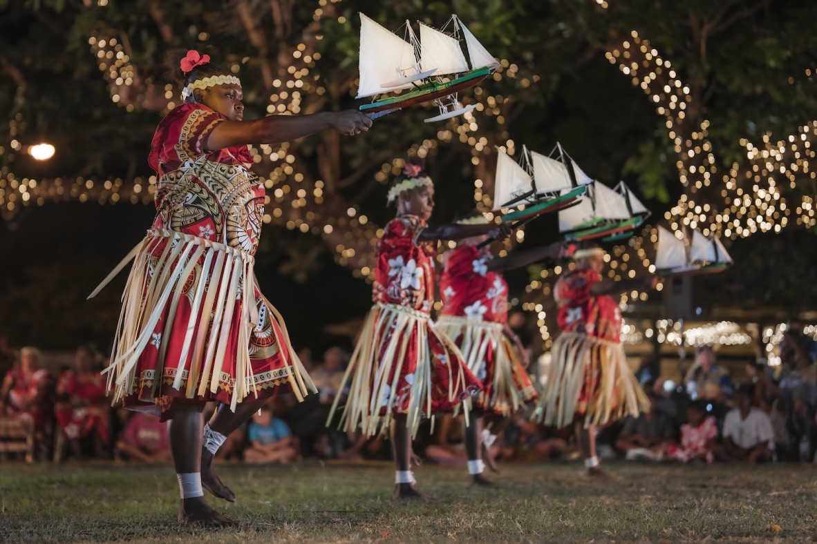 Torres Strait Islander dancers waving small sailboats.