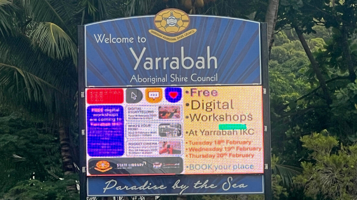 Sign saying Welcome to Yarrabah Aboriginal Shire Council with electronic display on free digital workshops