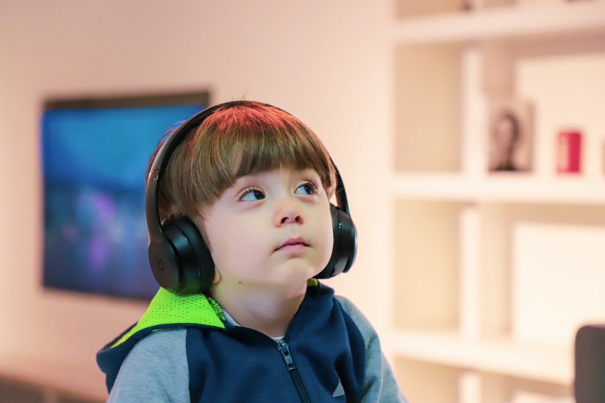 Young boy watching screen with headphones