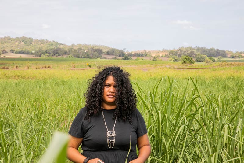 Woman standing in a cane field