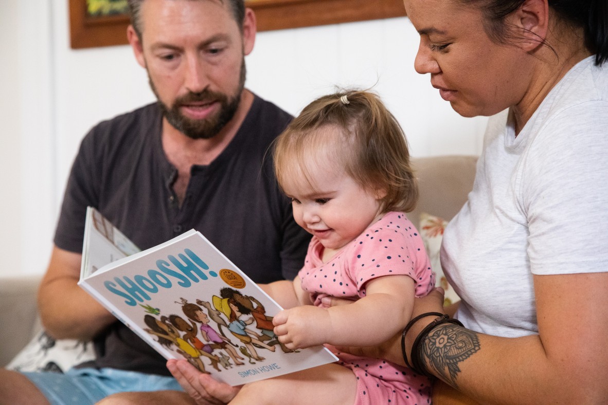 Baby looking at the pages of a book