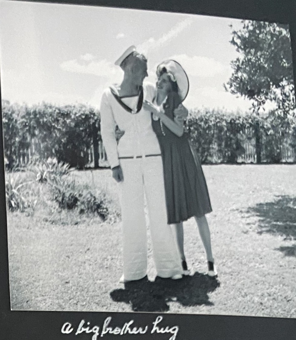 A hug shared between a Sailor and his sister in their garden