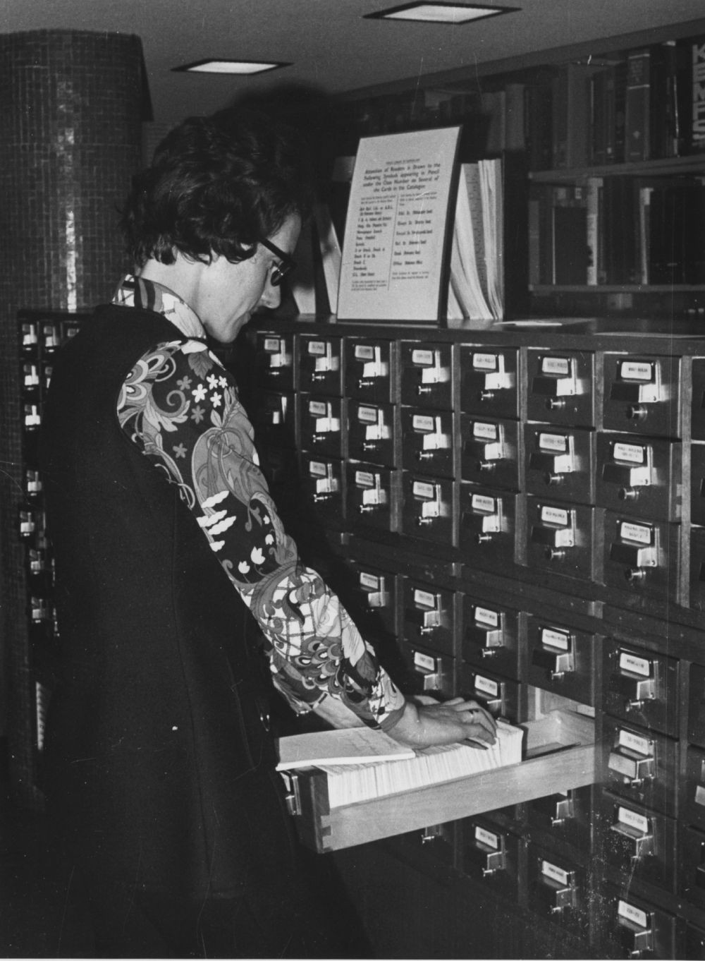 Librarian browsing the card catalogue inside the State Library of Queensland, Brisbane, 1971