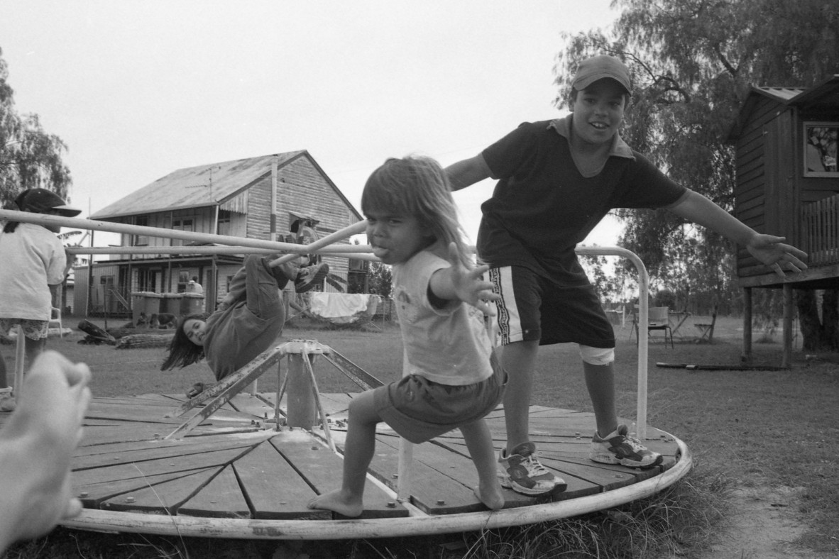 Children playing on a merry-go-round in Coominya, Queensland