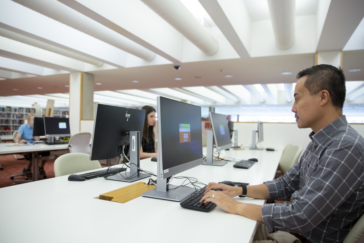 Man using computer at State Library Queensland