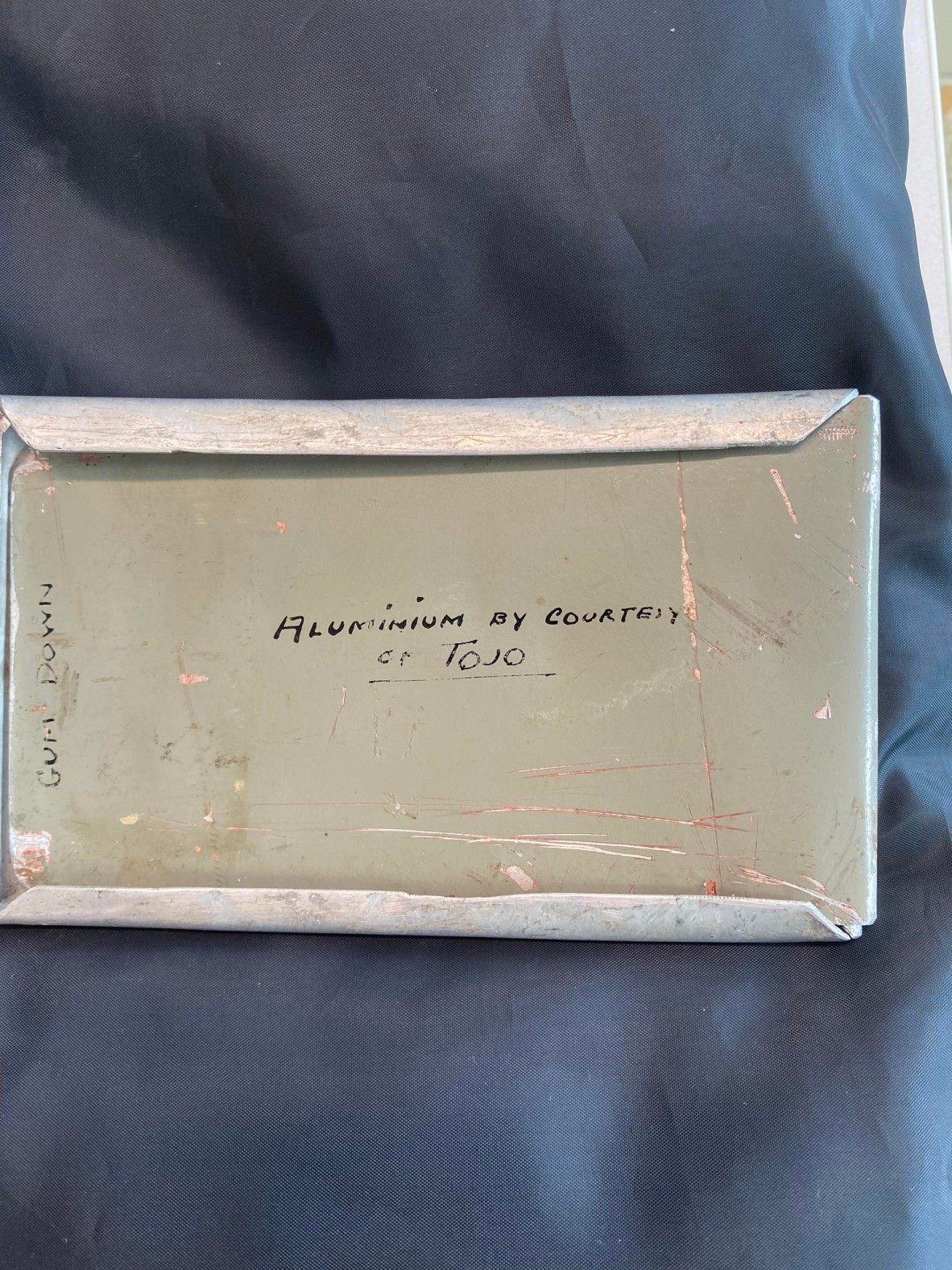 reverse of metal envelope made from fighter plane text reads  aluminium by courtesy of Tojo- Commander of the Japanese in WW2