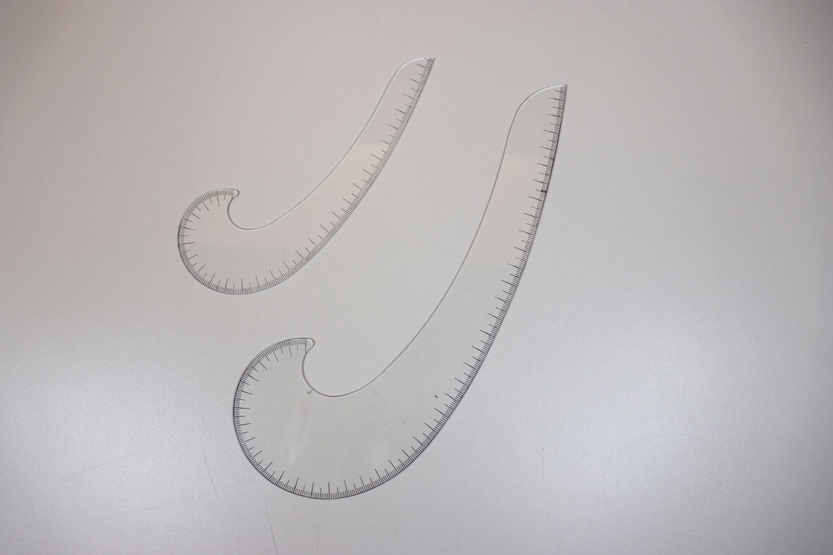 A photo of two different French curves, clear in colour.