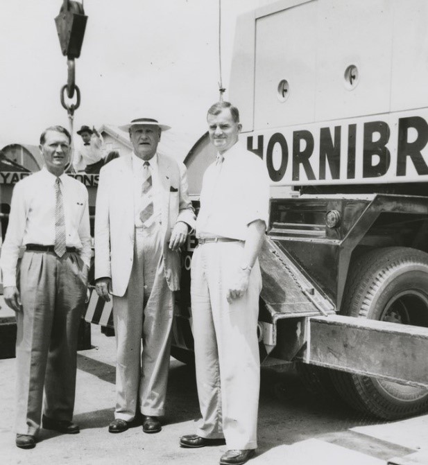 three men stand behind a truck on a Hornibrook construction site.