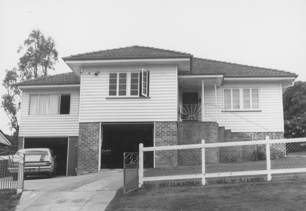 A house with three gables and a car in the driveway