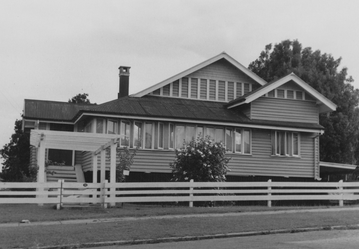 A multi gable house with a fence and stairs