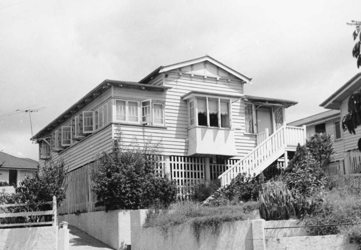 A multi gable house with a staircase at the side