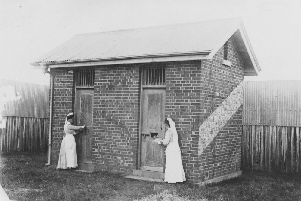 two nurses attend to patients in quarantine