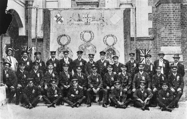 Queensland Railway drivers and firemen at the Roma Street Depot wearing badges made of red cloth.