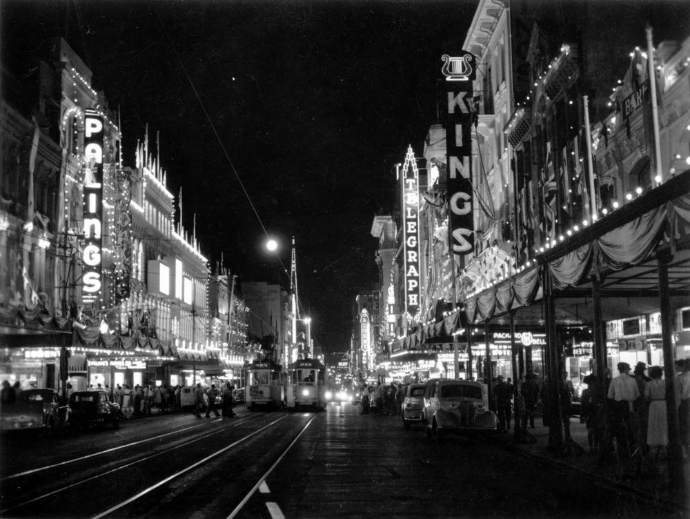 Queen Street, Brisbane, with decorations for the royal visit in 1954 - between George and Albert Streets. State Library of Queensland. Negative number: 62460