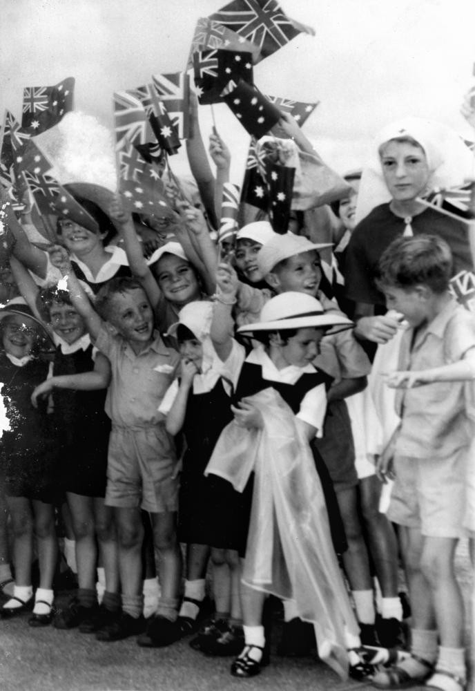 Flag-waving schoolchildren line the route that Queen Elizabeth II and Prince Philip will travel, Brisbane, 1954