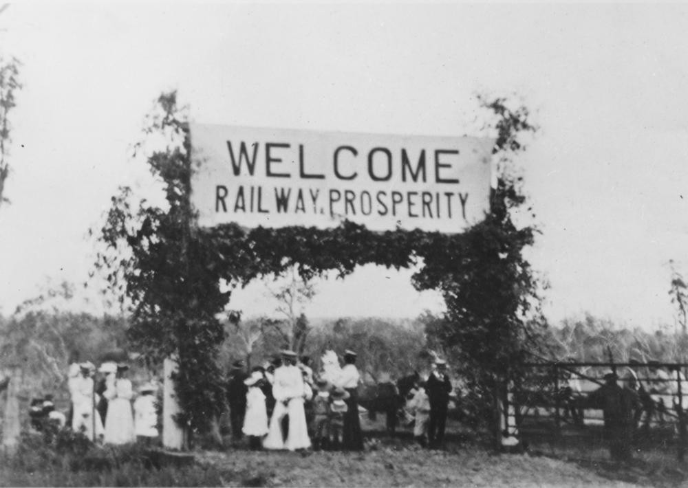 Group of people standing under a welcome sign at Kingaroy railway station 1904 